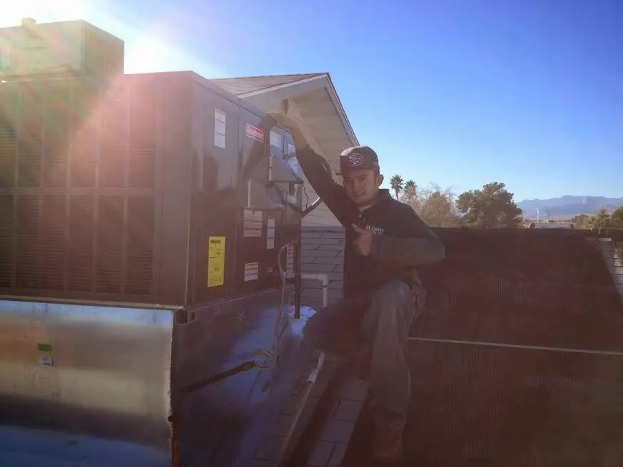 HVAC technician performing Boiler Repair on a rooftop unit in Upper Leacock